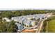 Aerial view of a planned community with colorful townhouses, mature trees, and city skyline in the distance at 754 Aerial Way, Atlanta, GA 30312