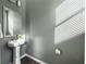Powder room featuring pedestal sink, mirror, and a neutral color scheme at 754 Aerial Way, Atlanta, GA 30312