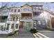 Charming multi-level townhome exterior with a colorful facade, balcony, and inviting entryway at 754 Aerial Way, Atlanta, GA 30312