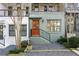 Attractive townhome exterior with a brightly colored front door, landscaped yard, and wrought iron railing at 754 Aerial Way, Atlanta, GA 30312