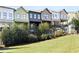 Lawn view of modern townhomes featuring balconies and lush landscaping in a well-maintained community at 754 Aerial Way, Atlanta, GA 30312