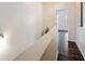 Hallway with light gray walls, dark wood-look floors and artwork hanging on the wall at 754 Aerial Way, Atlanta, GA 30312