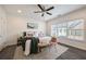 A bright bedroom features hardwood floors, a large window and soft, modern décor at 754 Aerial Way, Atlanta, GA 30312