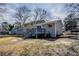 Backyard view showcasing a deck with stairs and ample green space at 810 N Carter Dr, Jonesboro, GA 30236