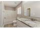 Bathroom features large tub/shower with tile surround, updated vanity, and tile floors at 810 N Carter Dr, Jonesboro, GA 30236