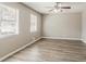 Bright bedroom with hardwood floors, ceiling fan, and natural light from the two large windows at 810 N Carter Dr, Jonesboro, GA 30236