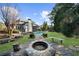 Expansive backyard with inground pool, stone fire pit and lush landscaping at 135 Newcastle Ct, Roswell, GA 30076