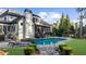 Backyard features a sparkling pool, patio with lounge chairs, and beautifully landscaped grounds at 135 Newcastle Ct, Roswell, GA 30076