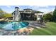Scenic backyard featuring a sparkling pool, large patio, and meticulously maintained landscaping at 135 Newcastle Ct, Roswell, GA 30076