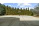 Private outdoor basketball court surrounded by mature trees at 135 Newcastle Ct, Roswell, GA 30076