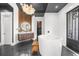 Luxury bathroom features a soaking tub, custom vanity with wood accents, and modern lighting at 135 Newcastle Ct, Roswell, GA 30076