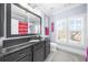 The bathroom includes tile floors, a vanity with a black countertop, decor, and a mirror for a spa-like experience at 135 Newcastle Ct, Roswell, GA 30076
