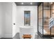 Bathroom with freestanding tub, glass shower, stone tile floor, and black framed door at 135 Newcastle Ct, Roswell, GA 30076
