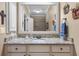 Bathroom boasts a granite countertop, mirror, and neutral decor with fixtures, for a spa-like experience at 135 Newcastle Ct, Roswell, GA 30076