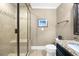 Modern bathroom featuring glass enclosed shower, granite countertops, and tile flooring at 135 Newcastle Ct, Roswell, GA 30076