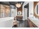 Bathroom features a sleek, freestanding tub, glass shower, and decorative wood vanities at 135 Newcastle Ct, Roswell, GA 30076