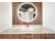 Bathroom vanity features light countertop, wood accents, a vessel sink, and circular mirror at 135 Newcastle Ct, Roswell, GA 30076