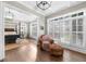 Bedroom with hardwood floors, four poster bed, and plantation shutters at 135 Newcastle Ct, Roswell, GA 30076