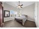 Cozy bedroom features vaulted ceilings, neutral walls, a ceiling fan, and plantation shutters for natural light and privacy at 135 Newcastle Ct, Roswell, GA 30076