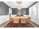 Stylish dining room with hardwood floors, chandelier, and ample natural light at 135 Newcastle Ct, Roswell, GA 30076