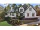 Charming two-story painted brick home featuring a landscaped yard and covered porch at 135 Newcastle Ct, Roswell, GA 30076