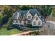 Beautiful two-story home with manicured landscaping, stone accents, and a welcoming front porch at 135 Newcastle Ct, Roswell, GA 30076