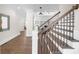 Elegant foyer with hardwood floors, staircase with decorative iron spindles, and classic architectural details at 135 Newcastle Ct, Roswell, GA 30076