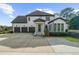 Beautiful two-story home with three-car garage and well-manicured landscaping at 135 Newcastle Ct, Roswell, GA 30076