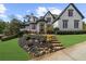 Inviting two-story home with well-maintained lawn, stone pathway, and charming front entrance at 135 Newcastle Ct, Roswell, GA 30076