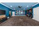 Spacious game room with blue walls, a ceiling fan, and decor that provides both entertainment and relaxation at 135 Newcastle Ct, Roswell, GA 30076