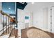 Bright hallway with white trim features wood floors, an area rug, and access to various rooms with neutral decor at 135 Newcastle Ct, Roswell, GA 30076