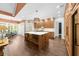 Open kitchen with a large island, stainless steel appliances, custom cabinetry, and dining nook at 135 Newcastle Ct, Roswell, GA 30076