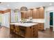 Beautiful kitchen featuring a marble island, custom cabinetry, and large windows for natural light at 135 Newcastle Ct, Roswell, GA 30076