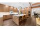Gorgeous kitchen with a large marble island, custom wood cabinets, and modern stainless steel appliances at 135 Newcastle Ct, Roswell, GA 30076