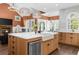 Charming kitchen with a large island, farmhouse sink, modern appliances, and dining space near a fireplace at 135 Newcastle Ct, Roswell, GA 30076