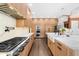 Spacious kitchen featuring custom wood cabinets, stainless appliances, quartz countertops and pendant lighting at 135 Newcastle Ct, Roswell, GA 30076