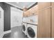 A modern laundry room with built-in cabinets, white marble countertops, and new washer and dryer at 135 Newcastle Ct, Roswell, GA 30076