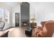 Bright living room featuring fireplace, hardwood floors, and stylish accent chair at 135 Newcastle Ct, Roswell, GA 30076