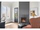 Cozy living room with fireplace, natural light, and comfortable seating at 135 Newcastle Ct, Roswell, GA 30076