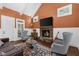 Cozy living room features a stone fireplace, vaulted ceilings, wainscoting, and hardwood floors at 135 Newcastle Ct, Roswell, GA 30076