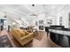 Elegant living room features a fireplace, custom shelving, and piano near a bay window, and staircase at 135 Newcastle Ct, Roswell, GA 30076