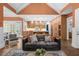 Open concept with vaulted ceilings, hardwood floors, and a glimpse of the kitchen from a well-lit living space at 135 Newcastle Ct, Roswell, GA 30076