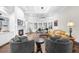 Bright living room boasts a fireplace, built-in shelving, plush seating, and a bay window with a piano at 135 Newcastle Ct, Roswell, GA 30076