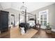 Main bedroom boasts vaulted ceiling, hardwood floors, and a four-poster bed with luxury furnishings at 135 Newcastle Ct, Roswell, GA 30076