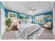 Inviting main bedroom with blue walls, a ceiling fan, plantation shutters, and decor for rest and relaxation at 135 Newcastle Ct, Roswell, GA 30076