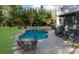 Inviting backyard pool and spa area with mature trees and outdoor seating at 135 Newcastle Ct, Roswell, GA 30076
