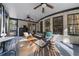 Relaxing screened porch featuring ceiling fans, comfortable seating, and serene backyard scenery at 135 Newcastle Ct, Roswell, GA 30076