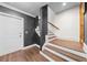 Modern staircase with a landing featuring a contrasting color scheme and a mix of dark and light wood tones at 135 Newcastle Ct, Roswell, GA 30076