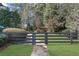 Fenced backyard with stone walkway and well-maintained lawn at 135 Newcastle Ct, Roswell, GA 30076