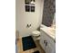 Well-lit bathroom features tiled floors, a white toilet, and a vanity sink with storage at 232 Rockingham Dr, Loganville, GA 30052